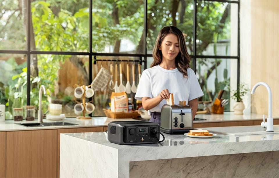Kobieta w kuchni wkłada tosty do tostera zasilanego przez stację EcoFlow RIVER 3