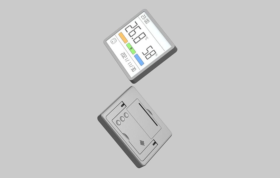 Dwa termo-higrometry na szarym tle – jeden widoczny przodu, drugi z tyłu